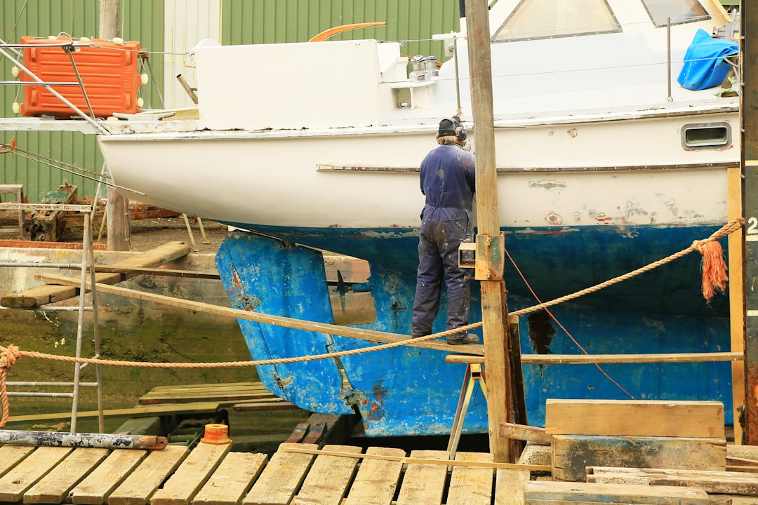 Hands maintaining boat engine